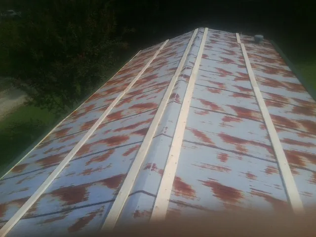 Rusted metal roof panels with new wood purlins before replacement — Storm Damage Roof Repair in North Bergen by Roofing Brothers