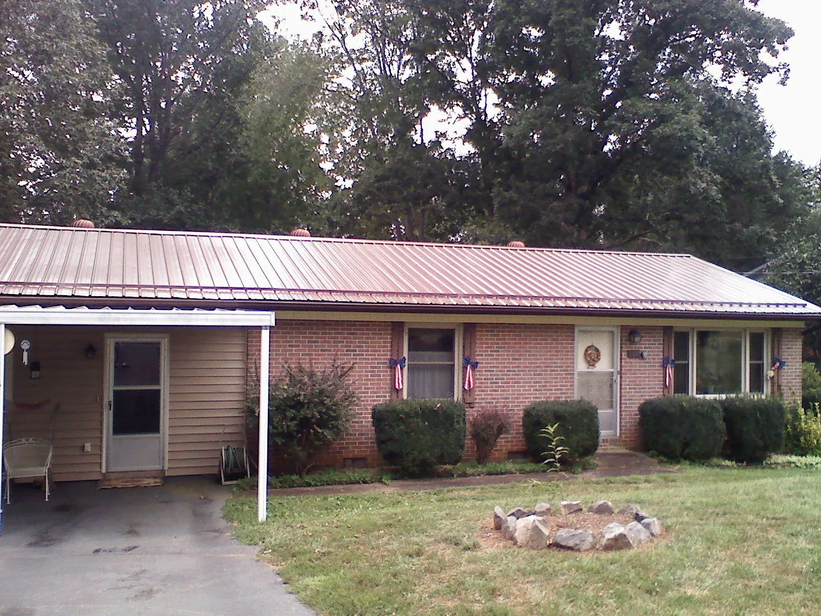Bronze metal roof and carport on a brick ranch home — Roof Repair work by our crew in North Bergen