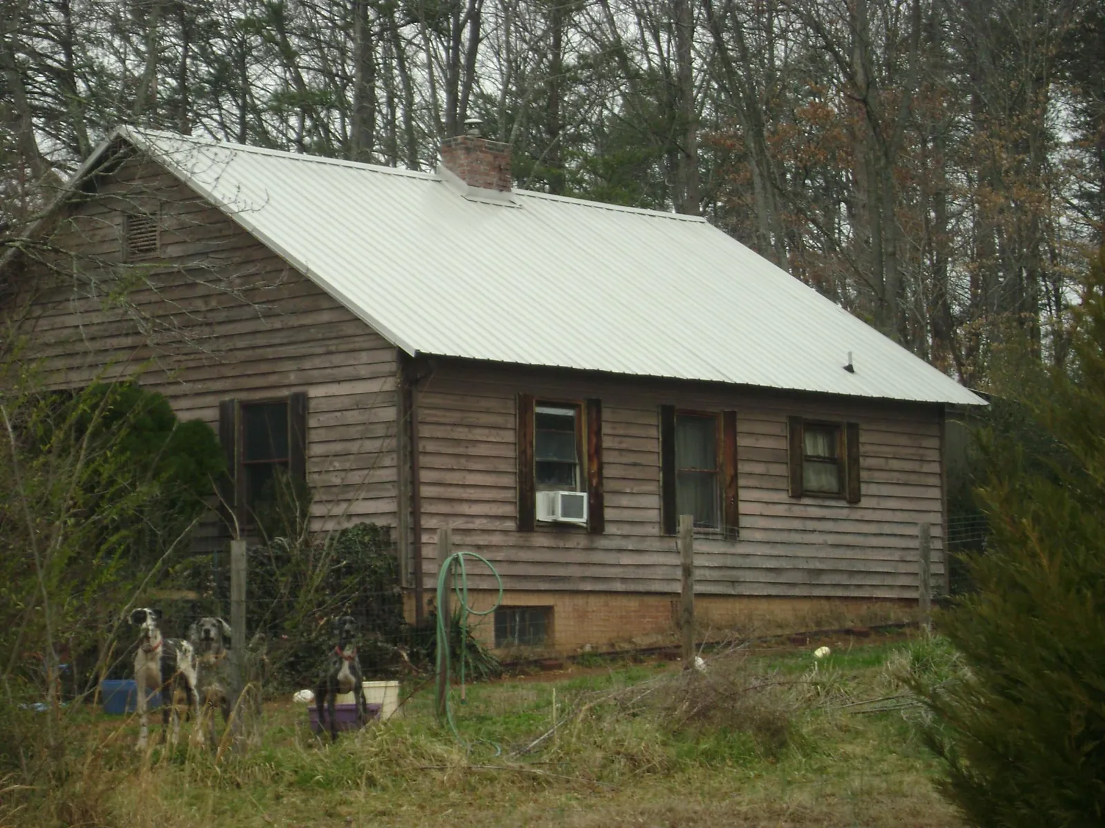 White metal roof on an old wood sided farmhouse, from a Metal Roof Installation job in North Bergen